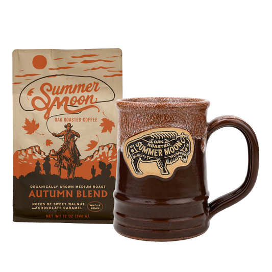 Summer Moon Autumn Blend coffee packaging bag next to a brown ceramic mug with a bison logo and the brand name 'Summer Moon' on the front, on a white background.
